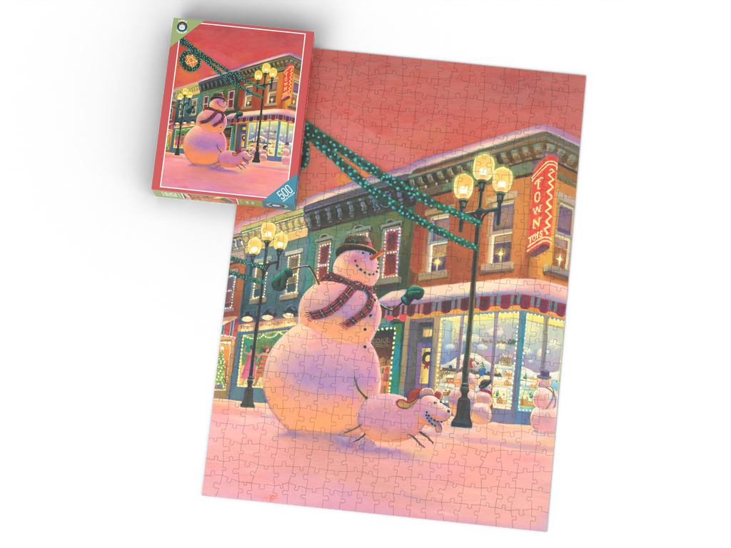 Snow Aglow puzzle box beside the completed puzzle